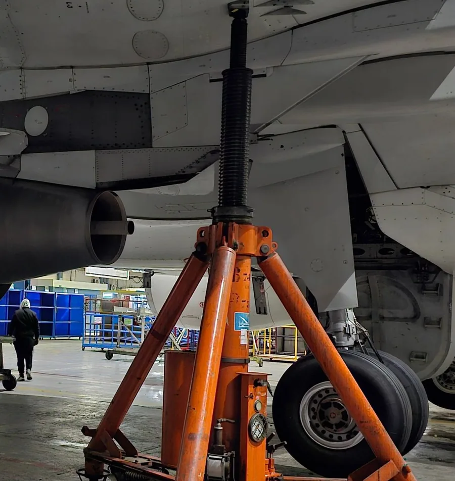 Aircraft on an orange jack under the wing during base maintenance